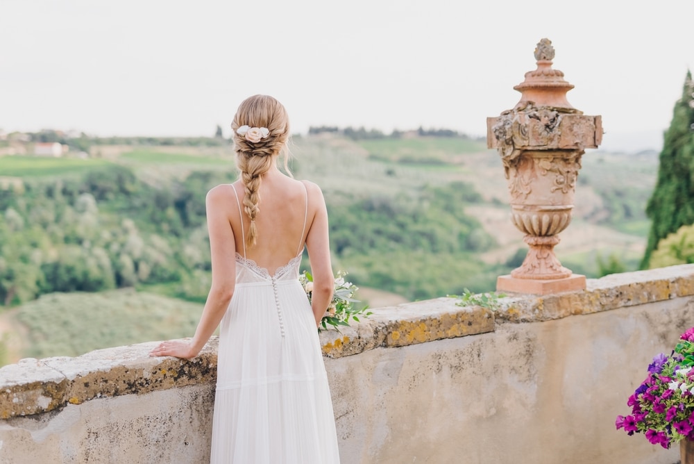 A,Beautiful,Young,Blonde,Bride,With,A,Braid,Stands,On