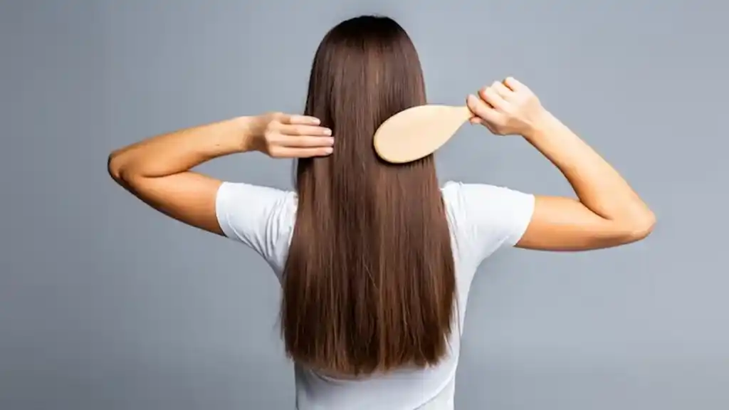 a lady combing her straight hair