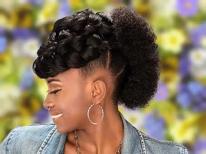 a lady wearing hoop earrings having a Mohawk hair style