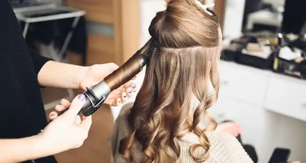 a stylist doing straight hair Curling Iron Waves