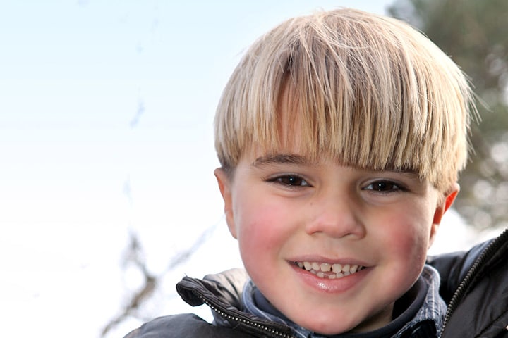 a young boy with a bowl haircut