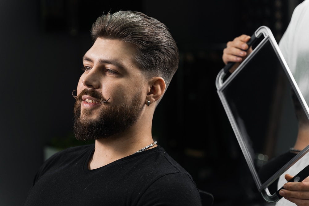 a barber showing faded haircut in the mirror