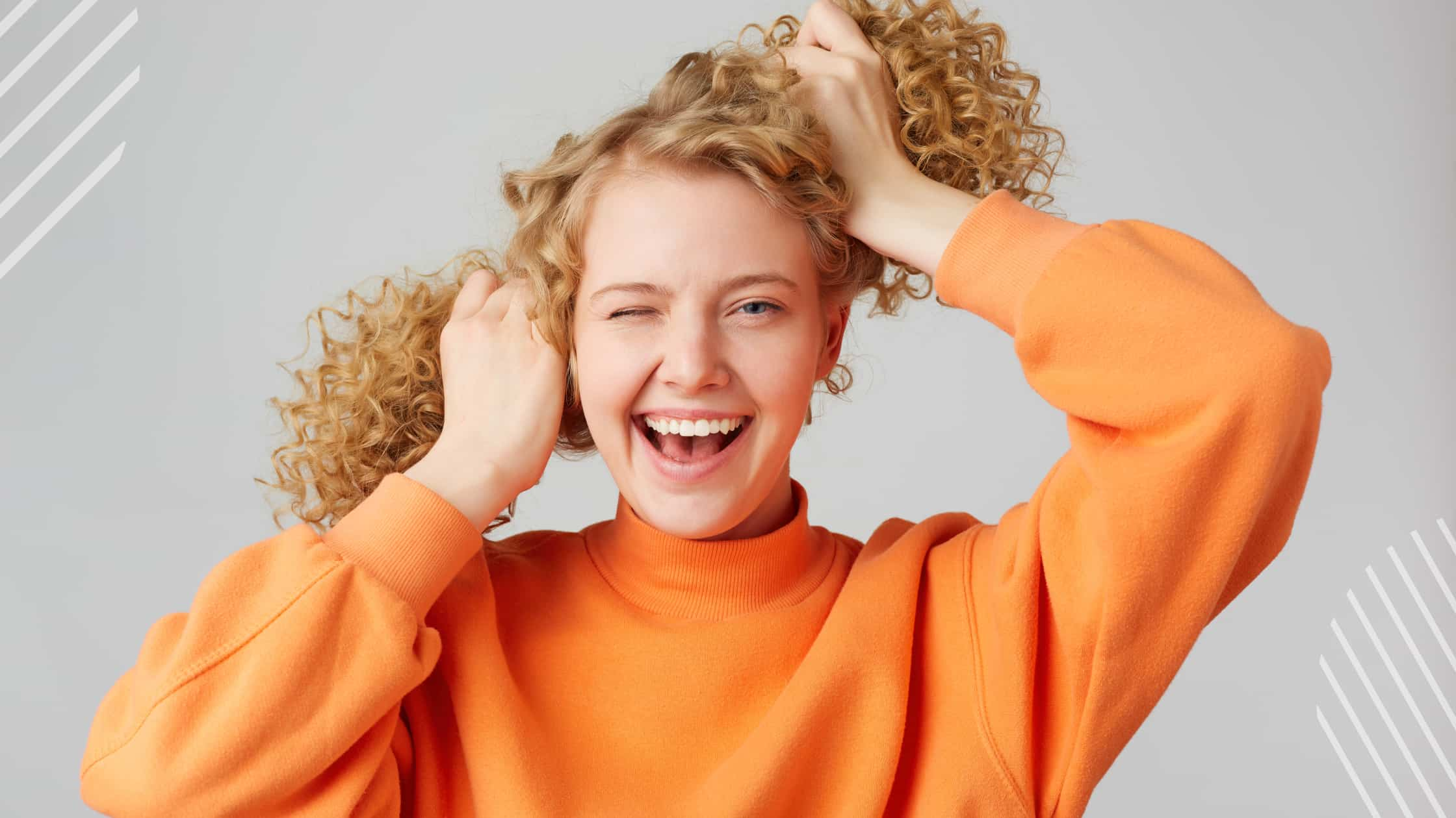 a lady making pineapple hair style on curly hair