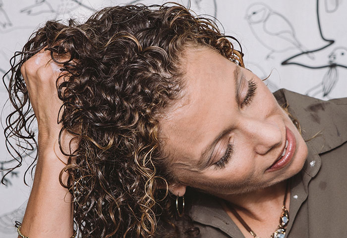 a lady washing her curly hair