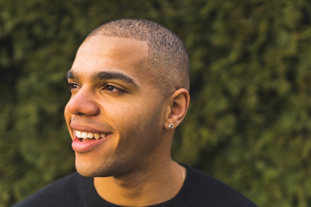 a young man with buzz cut and smiling face