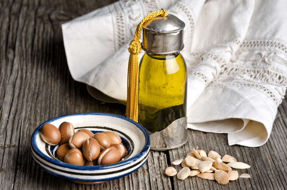 Bottle of argan oil and argan fruit.